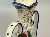 a white vase with a blue and white design on it