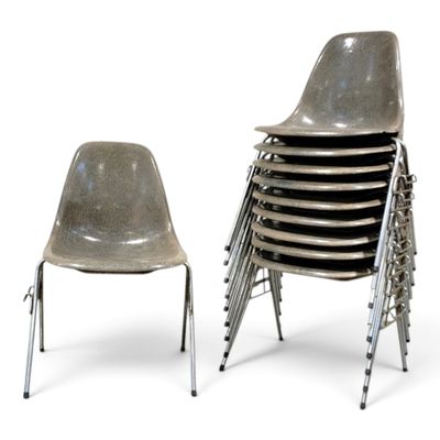a lot of chairs sitting next to each other on a white surface
