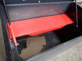 a black box with a red shelf inside of it