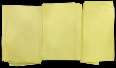 four folded yellow napkins on a black background