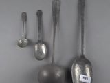three silver spoons and two silver spoons on a gray surface