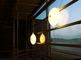three lights that are hanging from the ceiling of a building