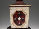 a small tortoise shell clock sitting on top of a table