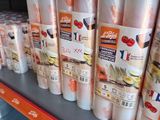many rolls of food on the shelf in the store