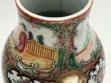 a vase with a design on it sitting on a table