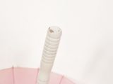 a pink umbrella with a white stick sticking out of it
