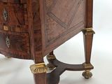 a small wooden table with a marble top on it