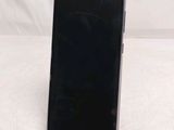 a close up of a cell phone on a stand on a white surface