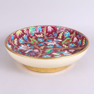 a bowl with a floral design on it sitting on a table
