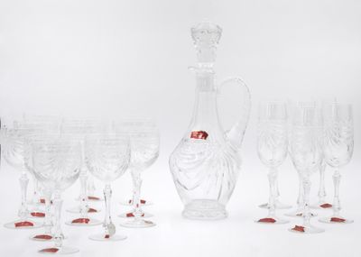 many wine glasses and a decanter on the table