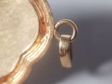 a close up of a gold locke with a ring on it