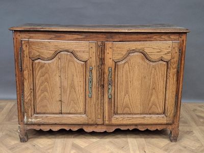 an old wooden cabinet with two doors and a drawer on top of it