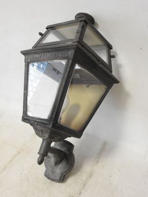an old fashioned light fixture mounted on a wall next to a white wall