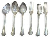 five spoons and a fork on a white surface