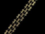 a close up of a gold bracelet on a black background