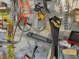 many tools hanging on the wall in the shop