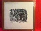 une image représentant un dessin d'un bâtiment, encadré et posé sur un tissu rouge