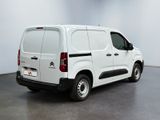 the white van is parked in the empty room of the building