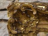 a picture of a gold frame with a painting on it