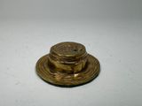 an old brass plate with a lid on a white surface