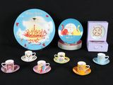 a lot of tea cups and saucers sitting on a table