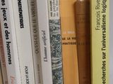 several books are stacked on top of each other on a table