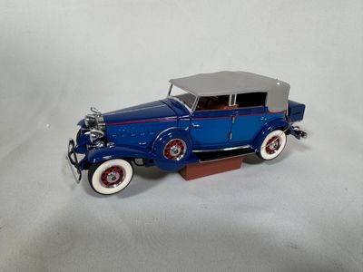 a toy car that is sitting on a white surface