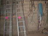 several ladders are leaning against a wall in an unfinished room