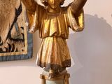 a statue of an angel that is on a table