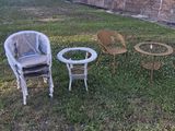 three chairs and a table in the yard