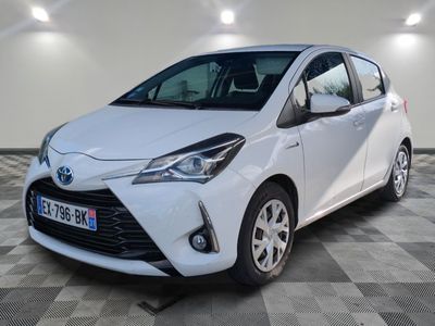 a white toyota yaris parked on a checkered floor