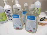 several bottles of hand sanitizer sitting on a counter next to other cleaning products
