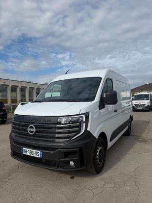 la camionnette blanche est garée dans un parking avec d'autres véhicules