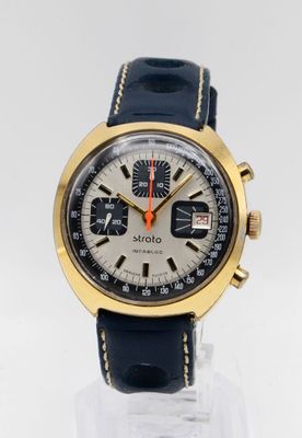 an image of a close up of a wrist watch on a clear surface