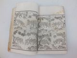 un vieux livre sur lequel figure une illustration d'animaux