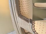 a close up of the back of a chair with a button on it