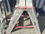a small metal step stool sitting on the ground