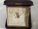 a small clock that is sitting on a table