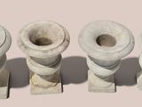 three white vases sitting next to each other on a table
