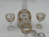 three glasses and a decanter sitting on a table