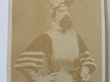 an old photo of a man wearing a hat and apron