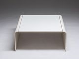 a close up of a white coffee table on a white surface
