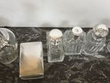 a marble counter top with a lot of bottles and a soap dispenser on it