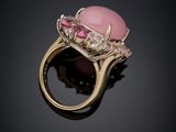 a close up of a pink stone and diamond ring on a black surface