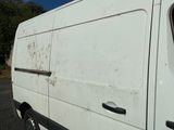 a white van that is parked on the side of the road