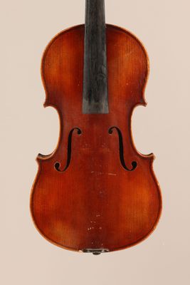an old violin with a bow hanging from it ' s back