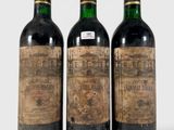 three bottles of wine sitting next to each other on a white surface