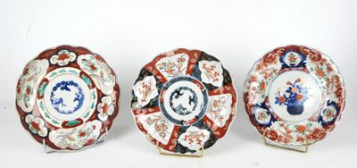three plates with different designs on them sitting next to each other
