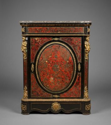 a red and black painted cabinet with gold accents