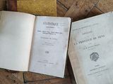 two open books sitting on top of a wooden floor next to each other